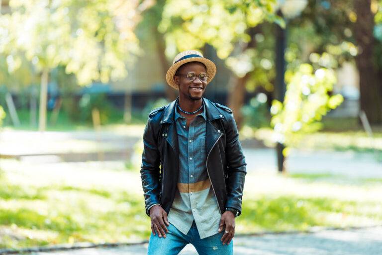 Portrait of afro american man in straw hat standing on the street